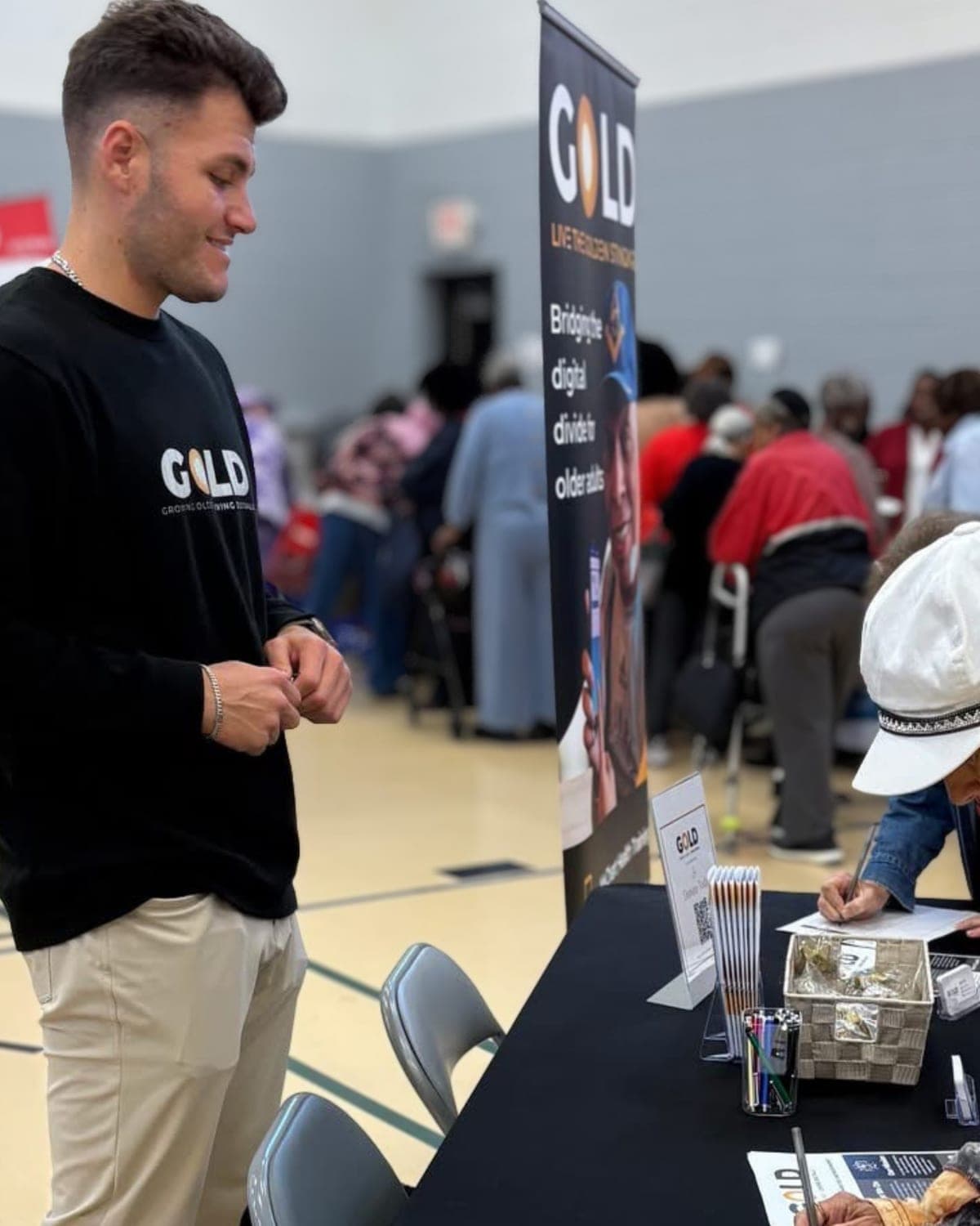 A GOLD staffer at the sign-up table during a community resource fair