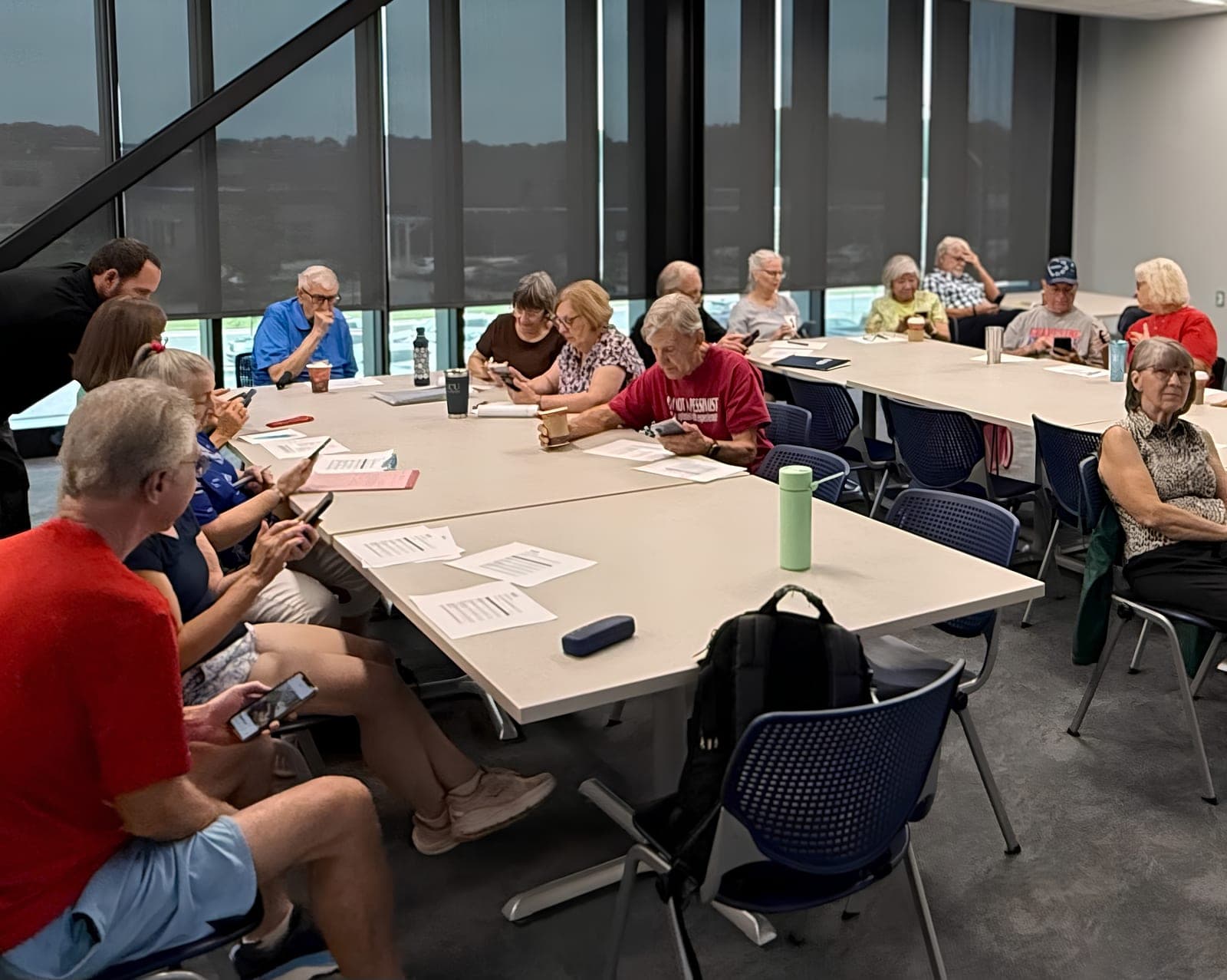 Older adults working through a lesson together at classroom tables